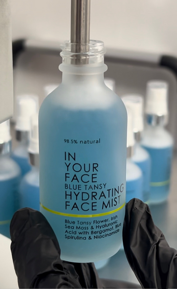 BLUE TANSY HYDRATING FACIAL MIST in gloved hand