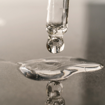 pipette of serum being poured on a surface