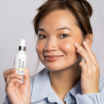 young woman holding up the PLUMPING SERUM
