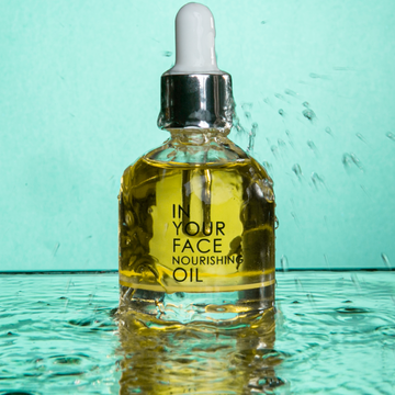bottle of NOURISHING OIL on an aqua background