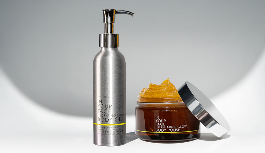 an image of the IN YOUR FACE HYDRATING CREAMY BODY OIL surrounded by cut up citrus on a white background