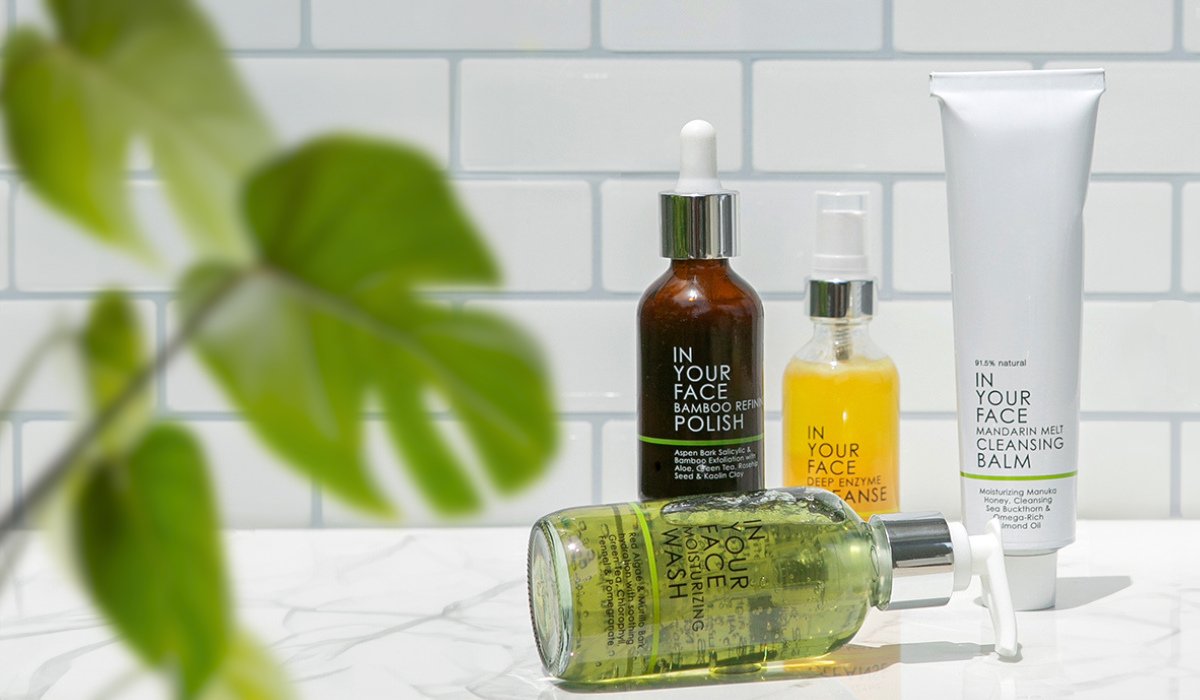 an image with tiles in the background and leaves showing the IN YOUR FACE SKINCARE cleansers