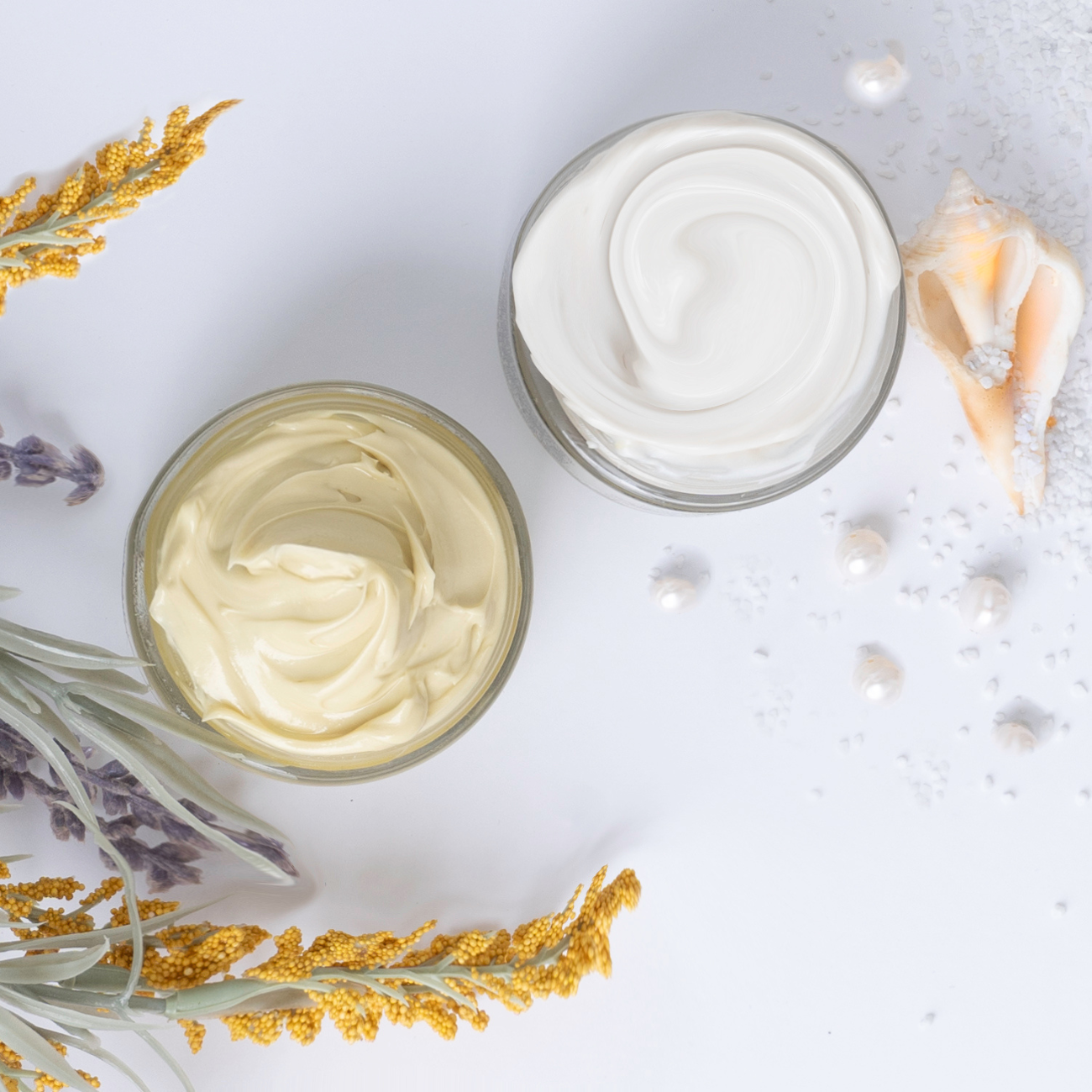 Image of 2 creams without caps looking down showing the cream