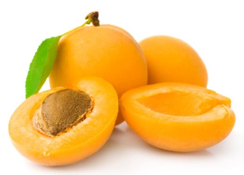 an image of 4 apricots, showing one cut open