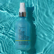 bottle of BLUE TANSY HYDRATING MIST floating in water