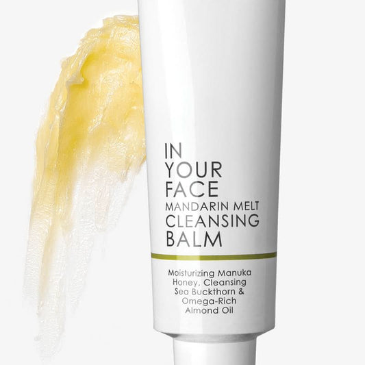 Cleansing balm tube with yellow cream on a white background