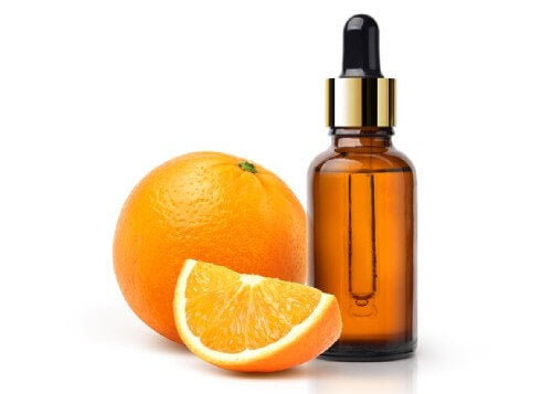 a picture of an orange with a bottle of essential oil