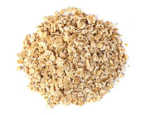 a pile of oat flakes on a white background