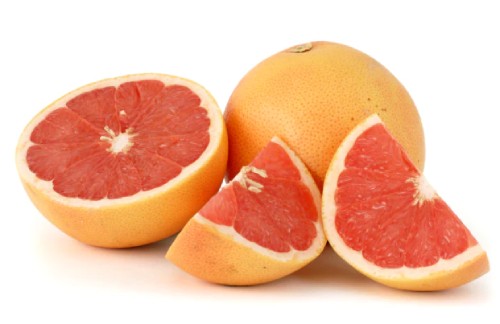 an image of chopped up pink grapefruit on a white background