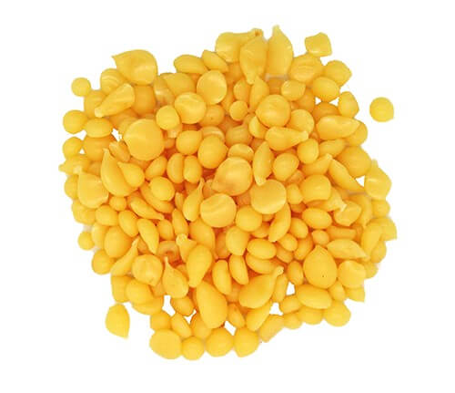an image of candelilla wax, showing yellow waxy pebbles