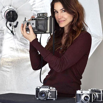 Denice Duff holding a camera up near her face