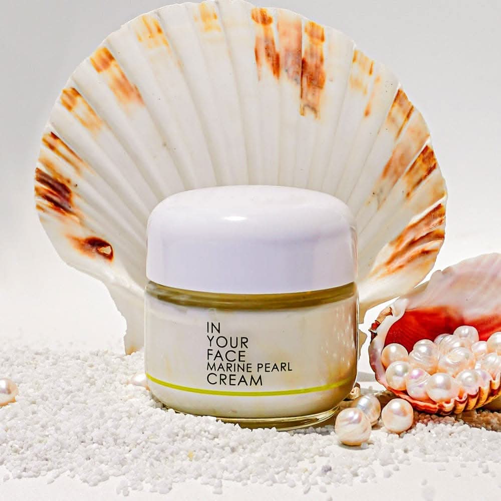 the MARINE PEARL CREAM with some shells, pearl and sand
