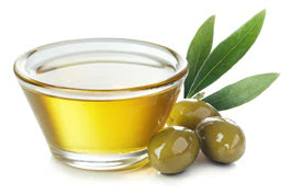 an image of a container of olive oil next to olives