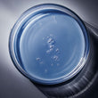 top view of serum in petri dish with reflections and shadows