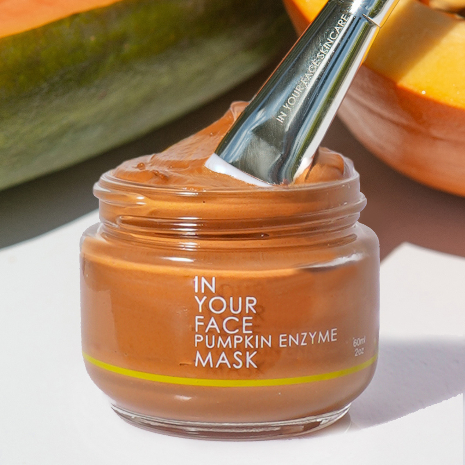 PUMPKIN ENZYME MASK with some papaya in the background