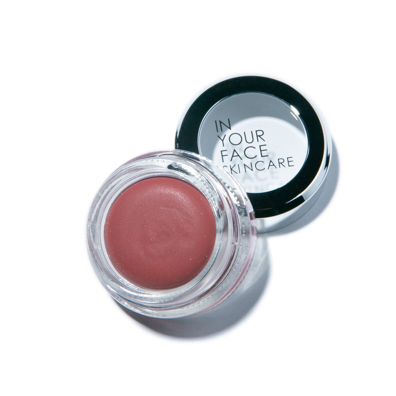 a pot of the IN YOUR FACE SKINCARE COLOR, showing it to be a deep rose in tone. It's in a glass jar.
