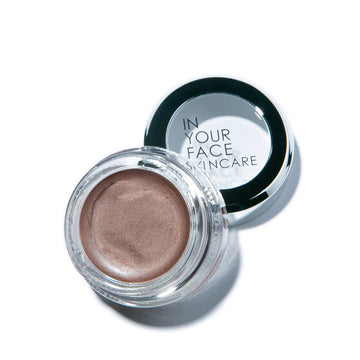 a pot of the IN YOUR FACE SKINCARE SHIMMER, showing it to be a shimmery medium brown in tone. It's in a glass jar.