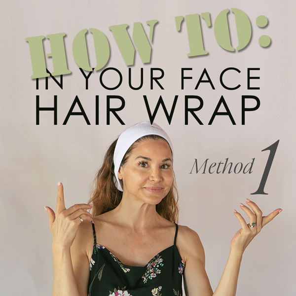 an image of Denice showing method #1 of putting on the HAIR WRAP: With it fully open, grab an end of the wrap in each hand and fasten the connection strip under your hair below your hairline in the back of your neck. Then, just lift up from the front to just at your hair line.