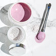 the RADIANT DETOX MASK, BRUSH and BOWL on marble.