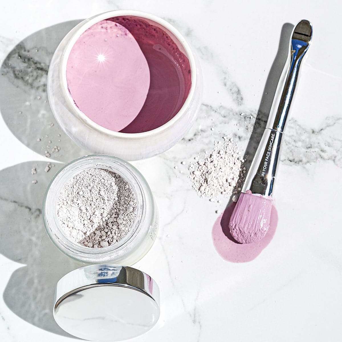 the RADIANT DETOX MASK, BRUSH and BOWL on marble.
