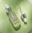 clarifying serum laying on green surface