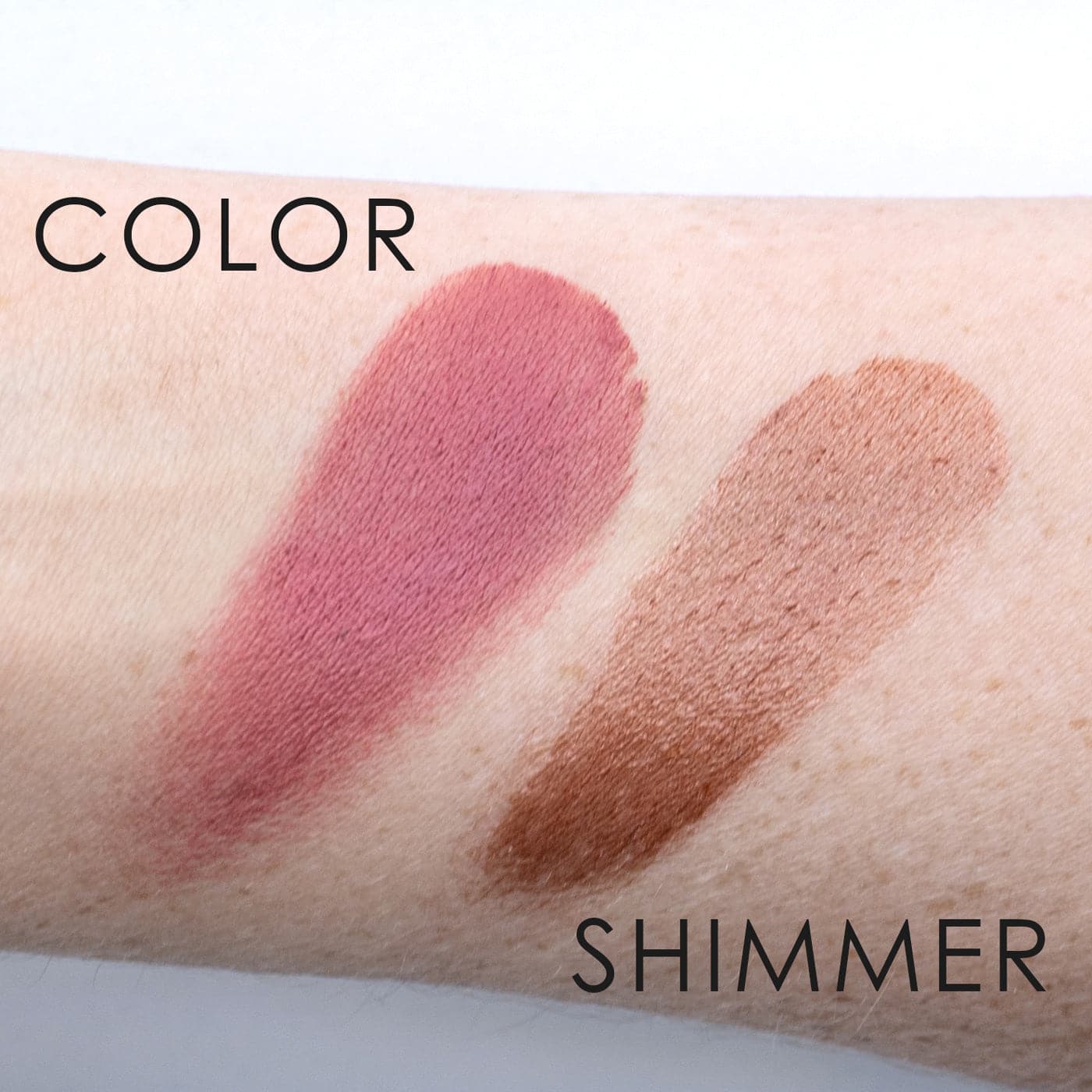 a swatch of the COLOR and the IN YOUR FACE SHIMMER on a pale arm, showing the deep rose tone of the COLOR and the shimmery medium brown color of the SHIMMER.