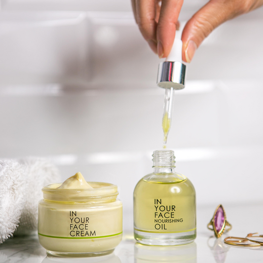 CREAM and NOURISHING OIL on tiled background.
