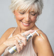 BODY OIL being held and squeezed by mature woman