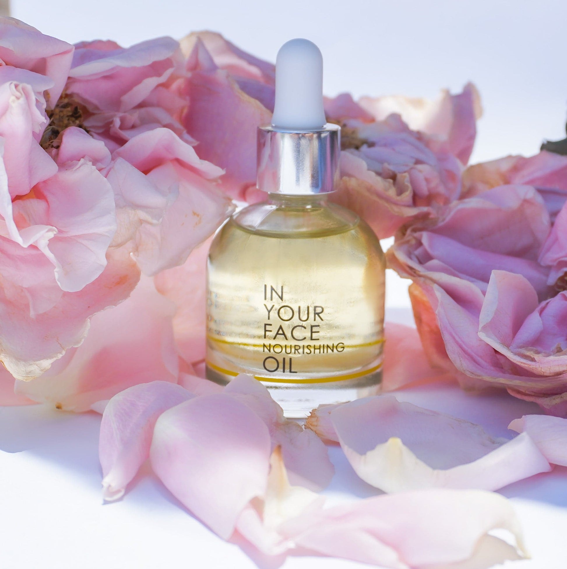 our nourishing oil among some peony petals