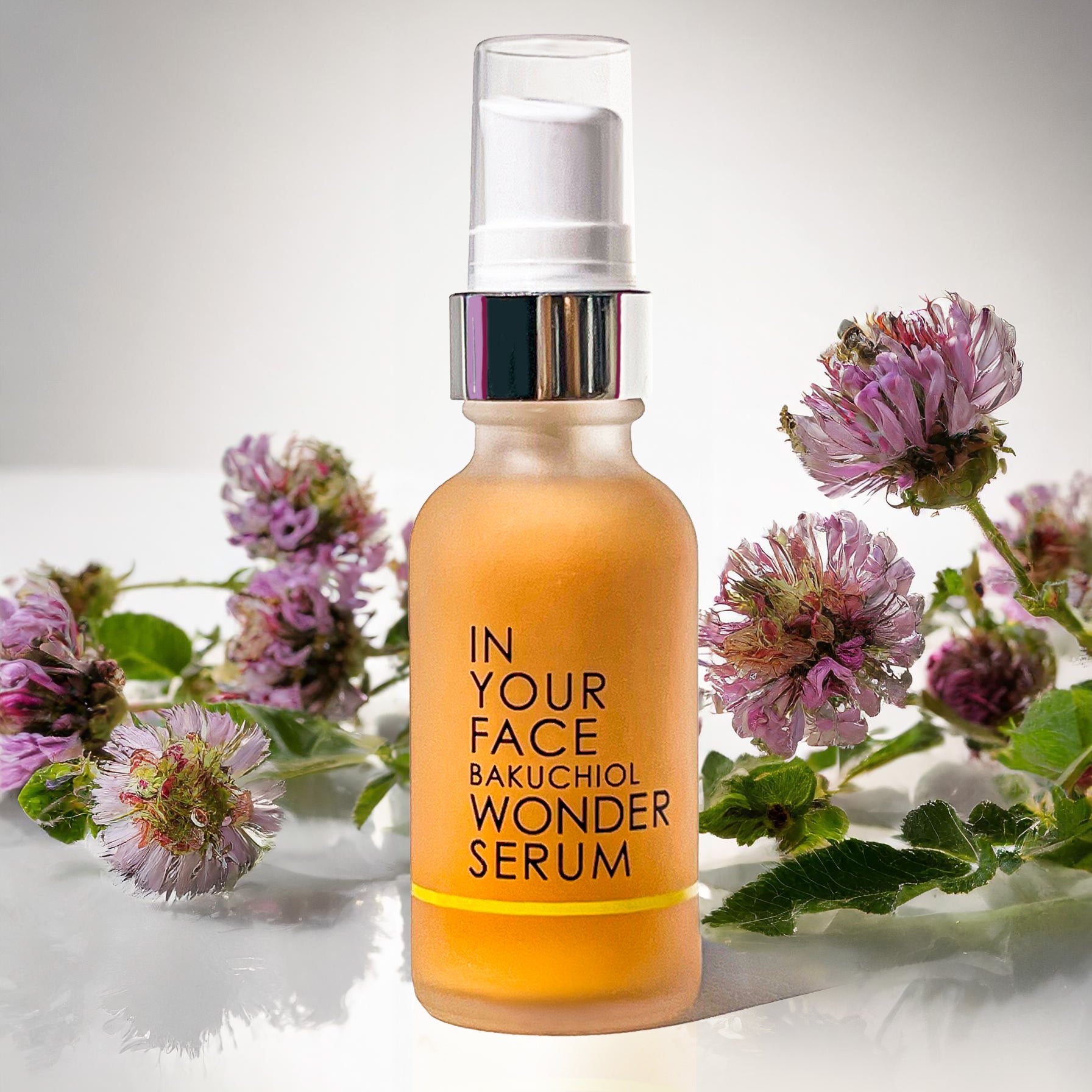 an image of the IN YOUR FACE BAKUCHIOL WONDER SERUM with bakuchiol flowers in the background