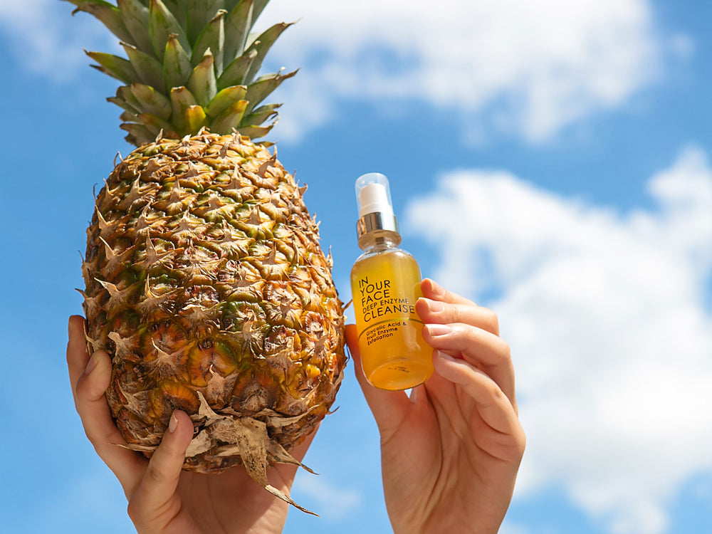 A hand in the sky holding the DEEP ENZYME CLEANSE and a pineapple. IN YOUR FACE DEEP ENZYME CLEANSE Uses Pineapple