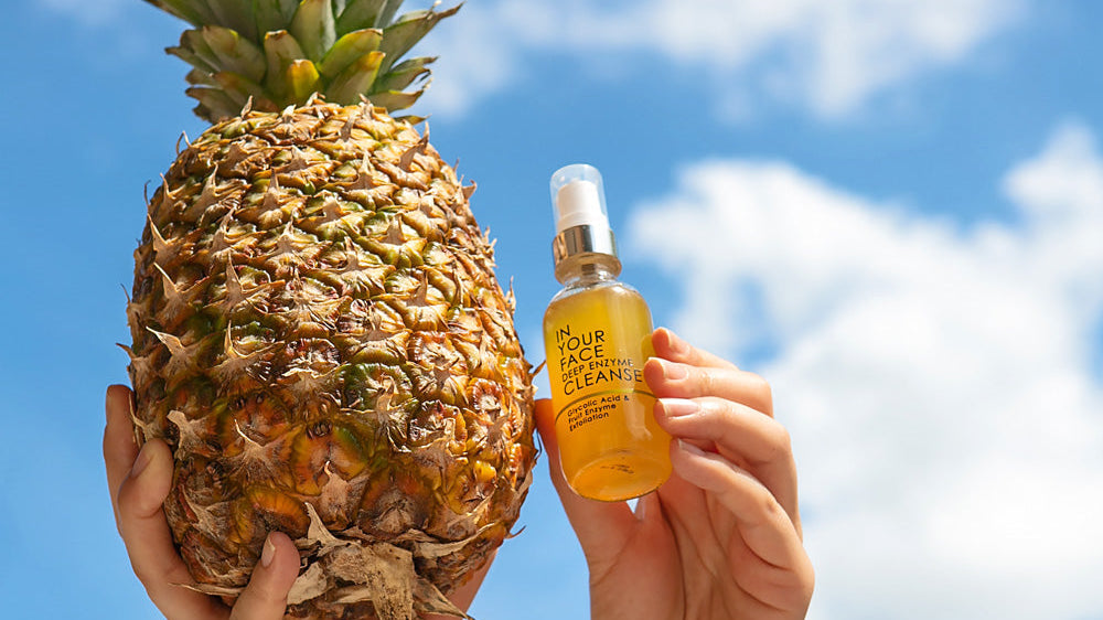 A hand in the sky holding the DEEP ENZYME CLEANSE and a pineapple. IN YOUR FACE DEEP ENZYME CLEANSE Uses Pineapple
