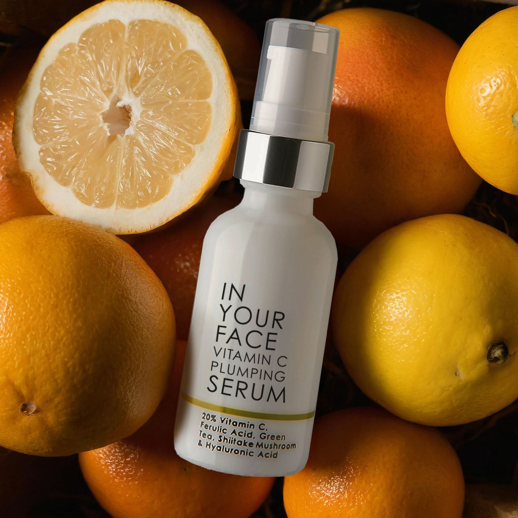 photo of VITAMIN C PLUMPING SERUM jar laying on oranges