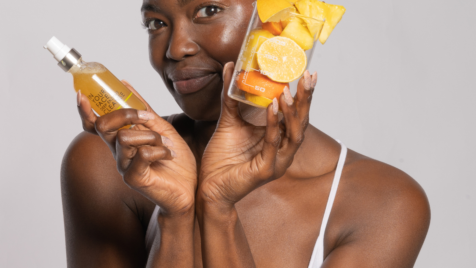 young black woman holding the DEEP ENZYME CLEANSE