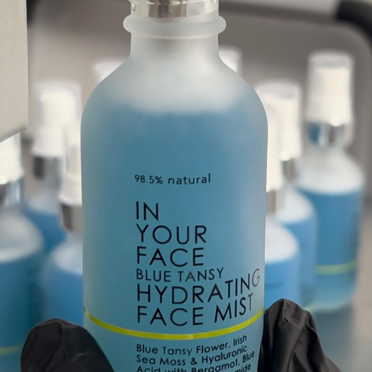 BLUE TANSY HYDRATING FACIAL MIST in gloved hand