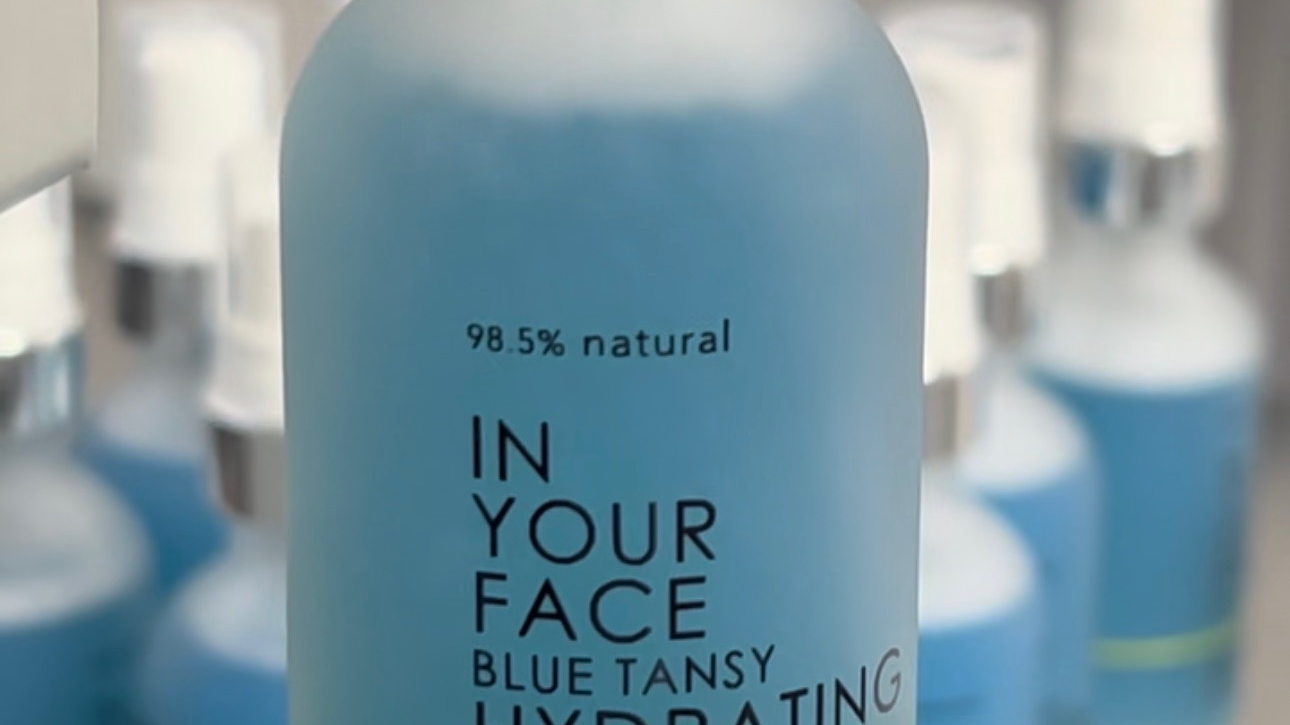 BLUE TANSY HYDRATING FACIAL MIST in gloved hand