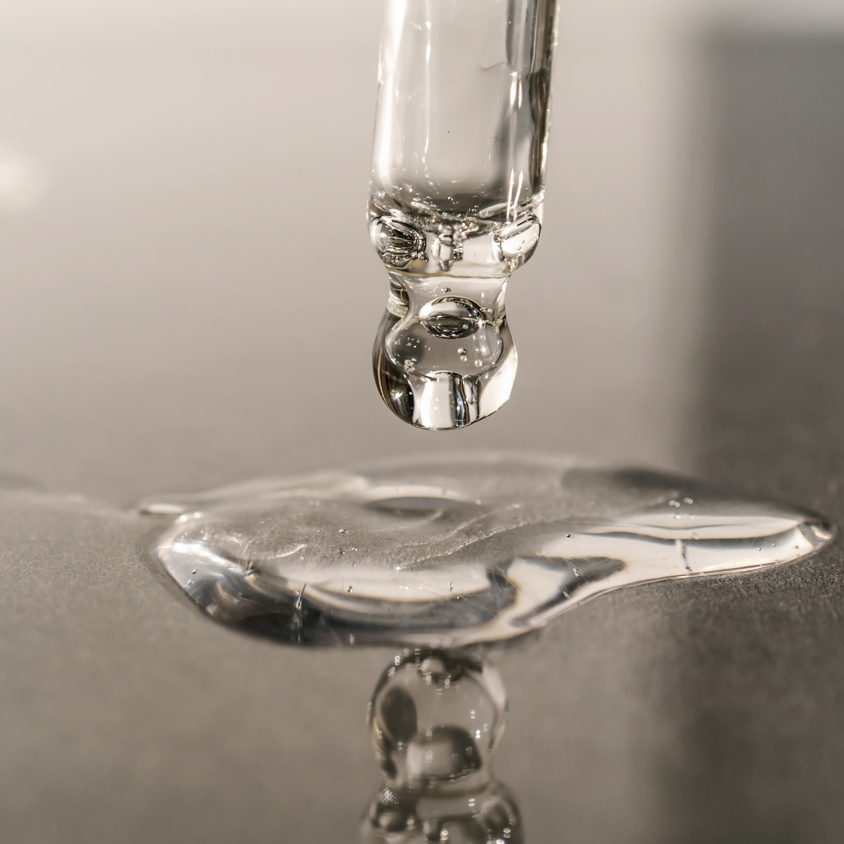 pipette of serum being poured on a surface