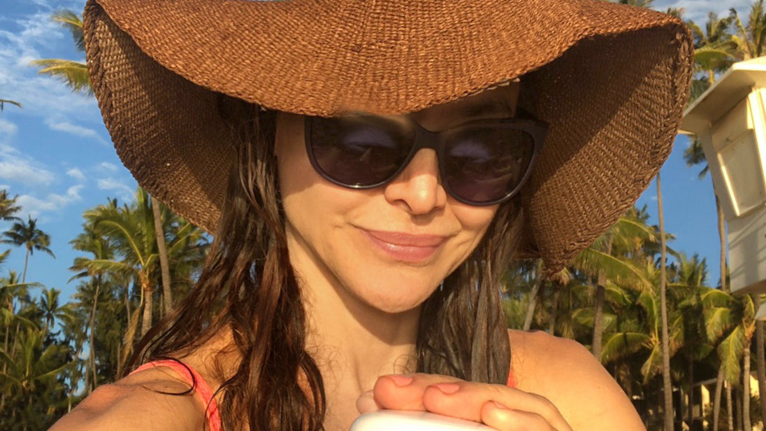 denice duff wearing a hat, holding a jar of IN YOUR FACE CREAM