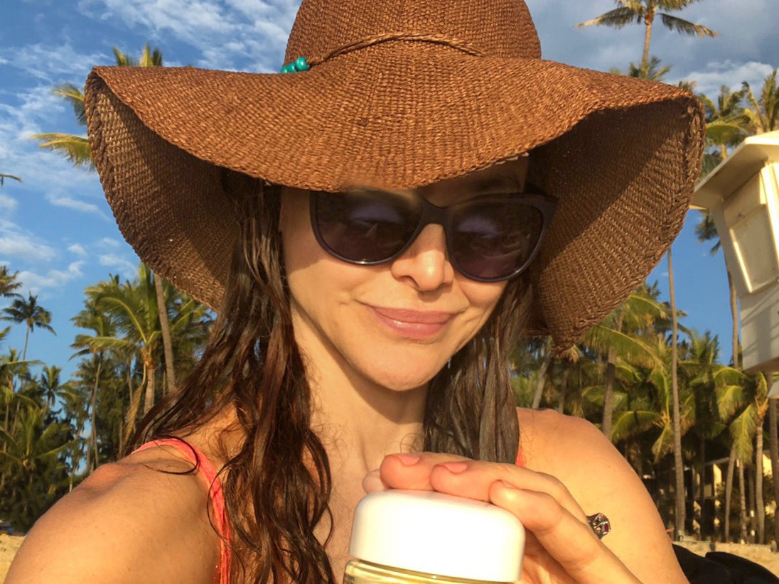 denice duff wearing a hat, holding a jar of IN YOUR FACE CREAM