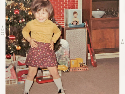Faded old photo of very young girl at Christmas with "Denice 1969 Long Island, NY" on it