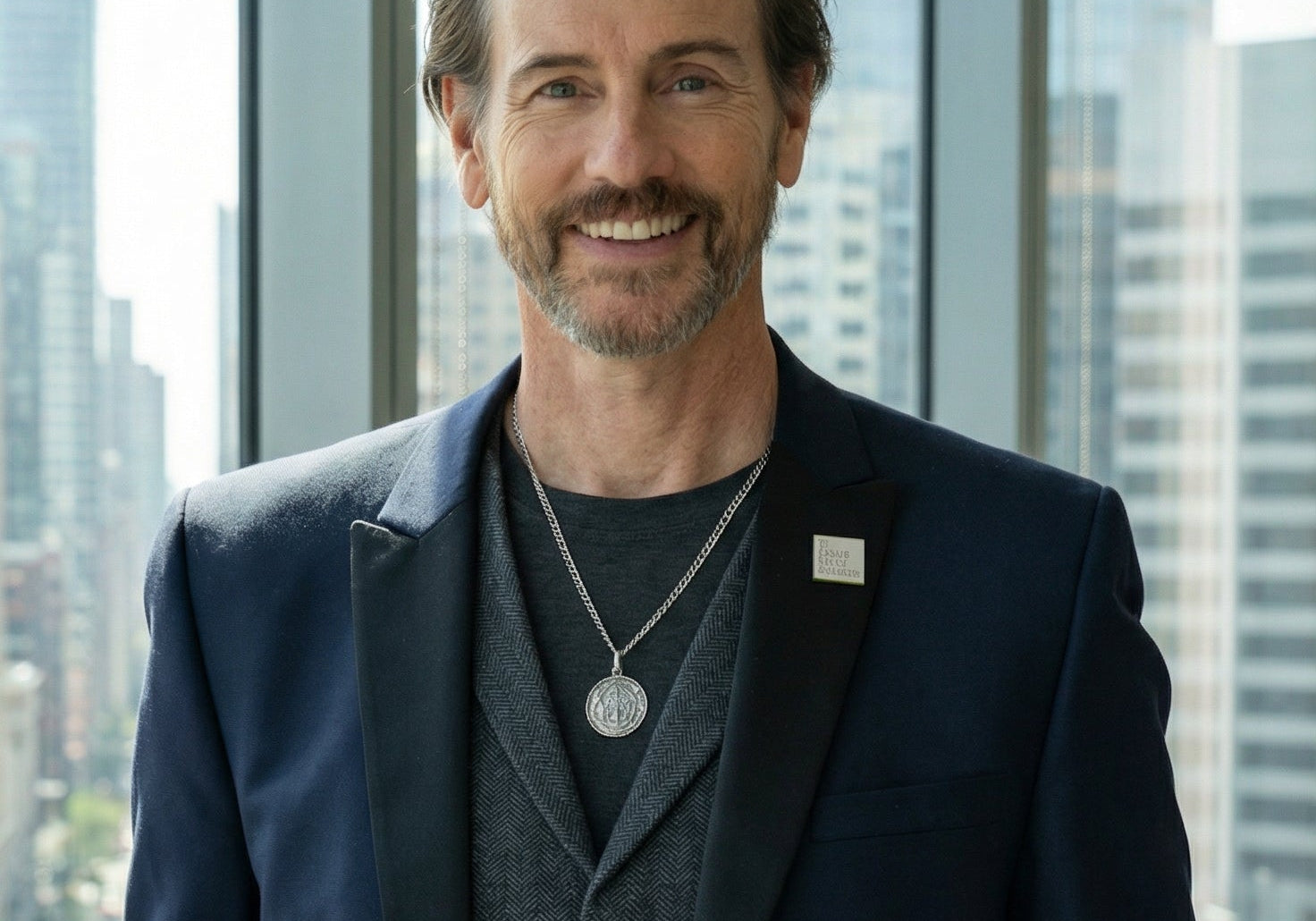 CEO Michael Duff stands in window of city highrise