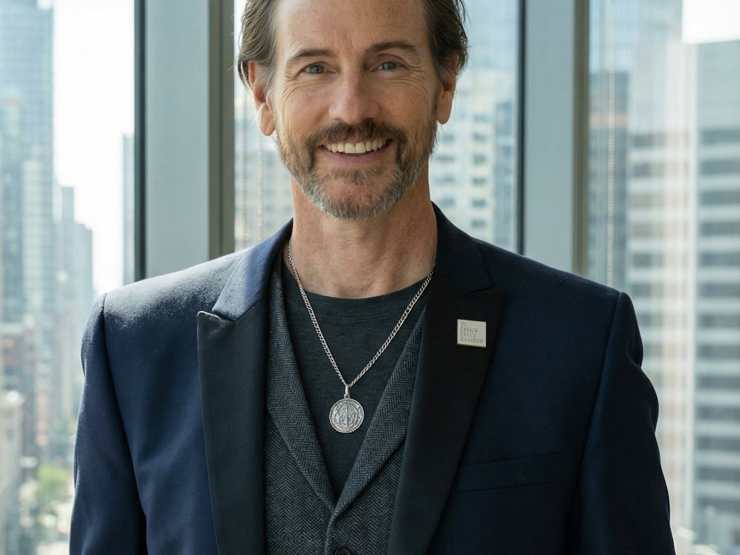 CEO Michael Duff stands in window of city highrise