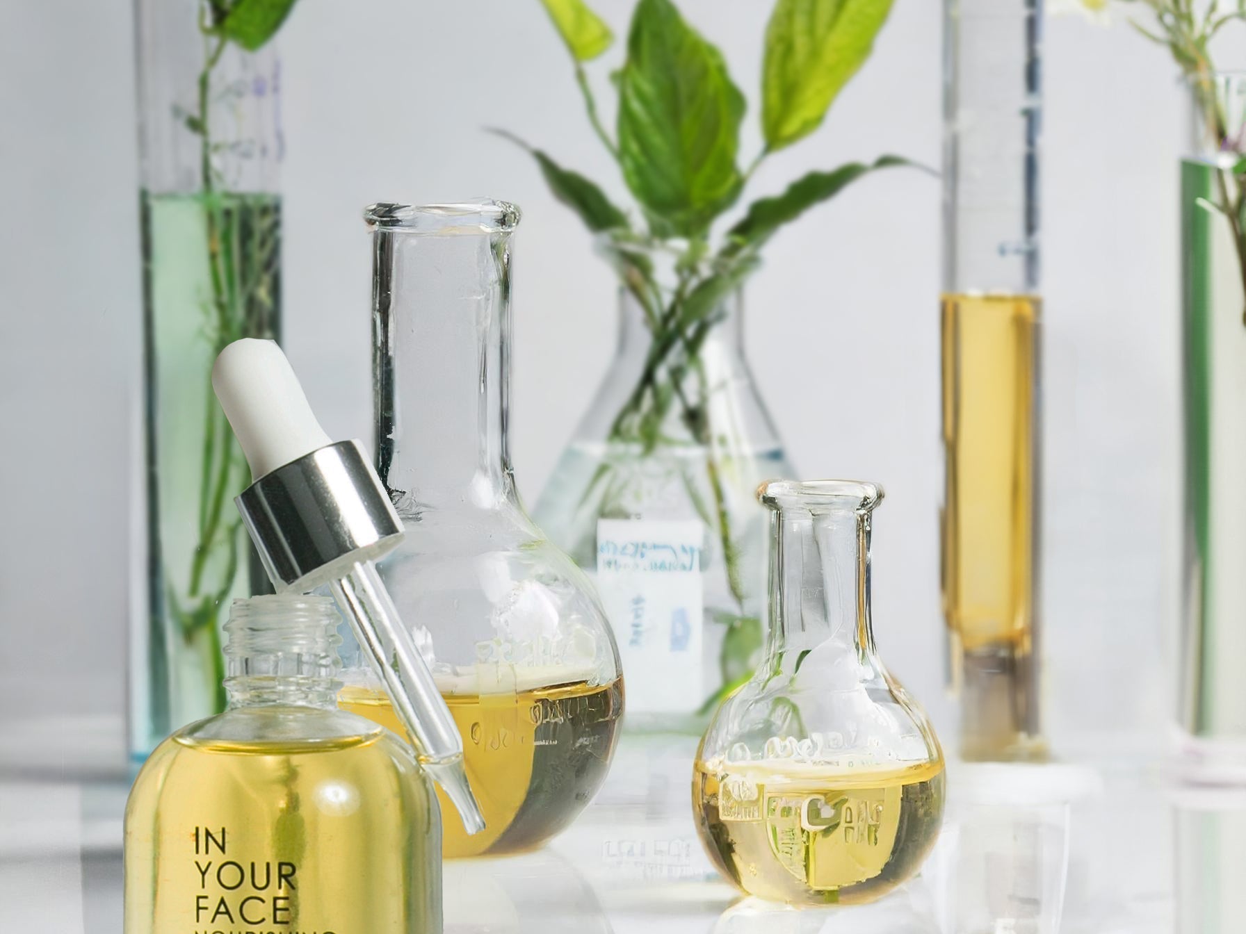 NOURISHING OIL surrounded by beakers of oil