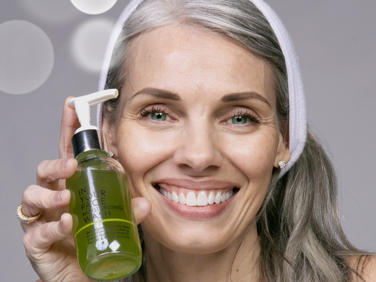 mature woman holding MOISTURIZING WASH in her hand