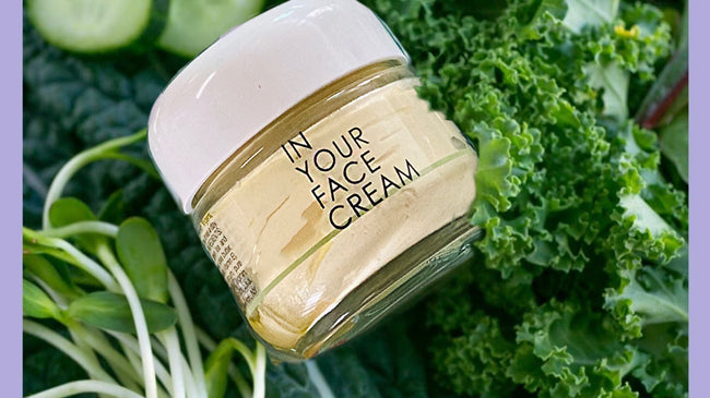 IN YOUR FACE CREAM surrounded by healthy greens