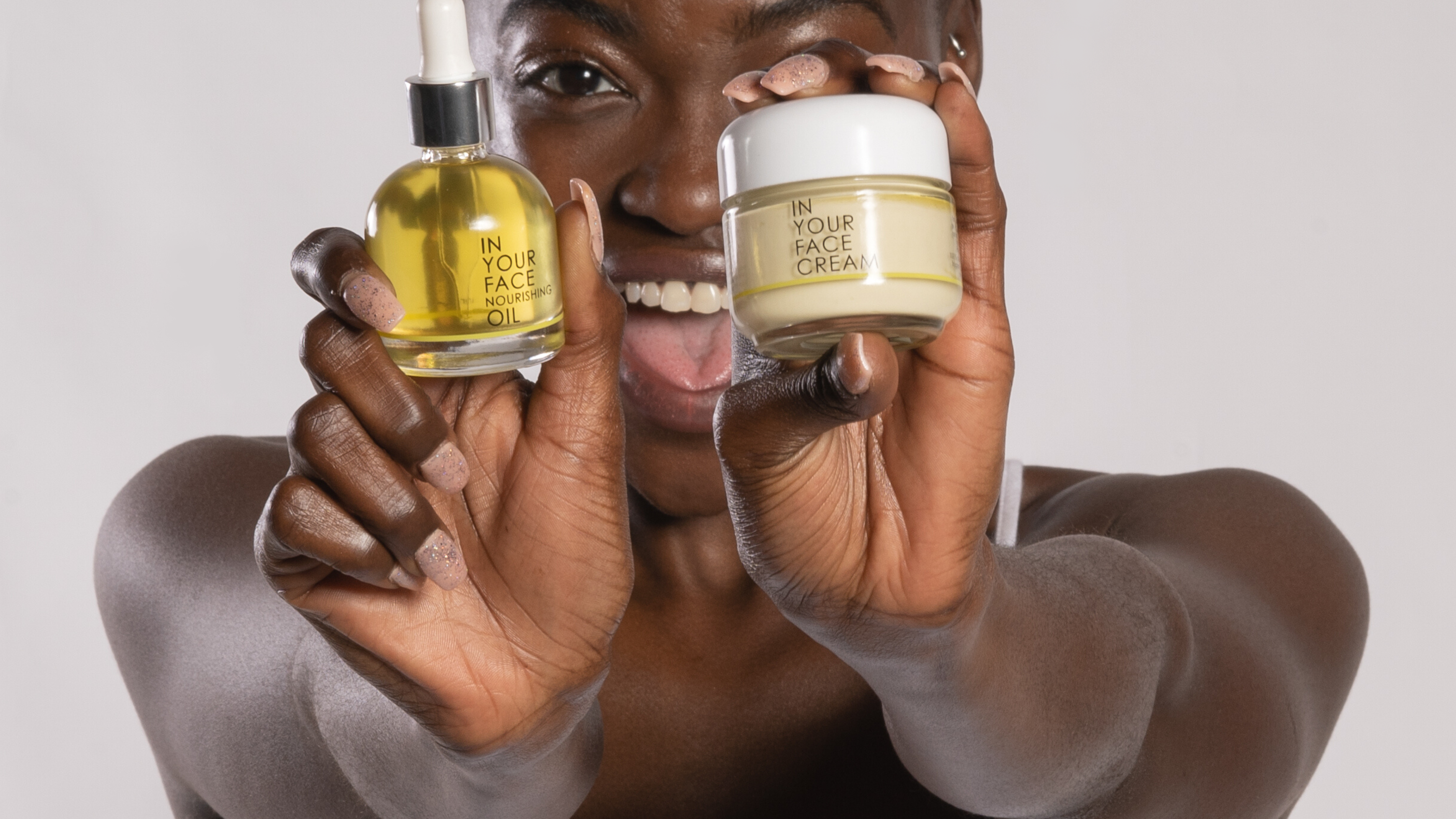 young black woman holding the OIL and CREAM