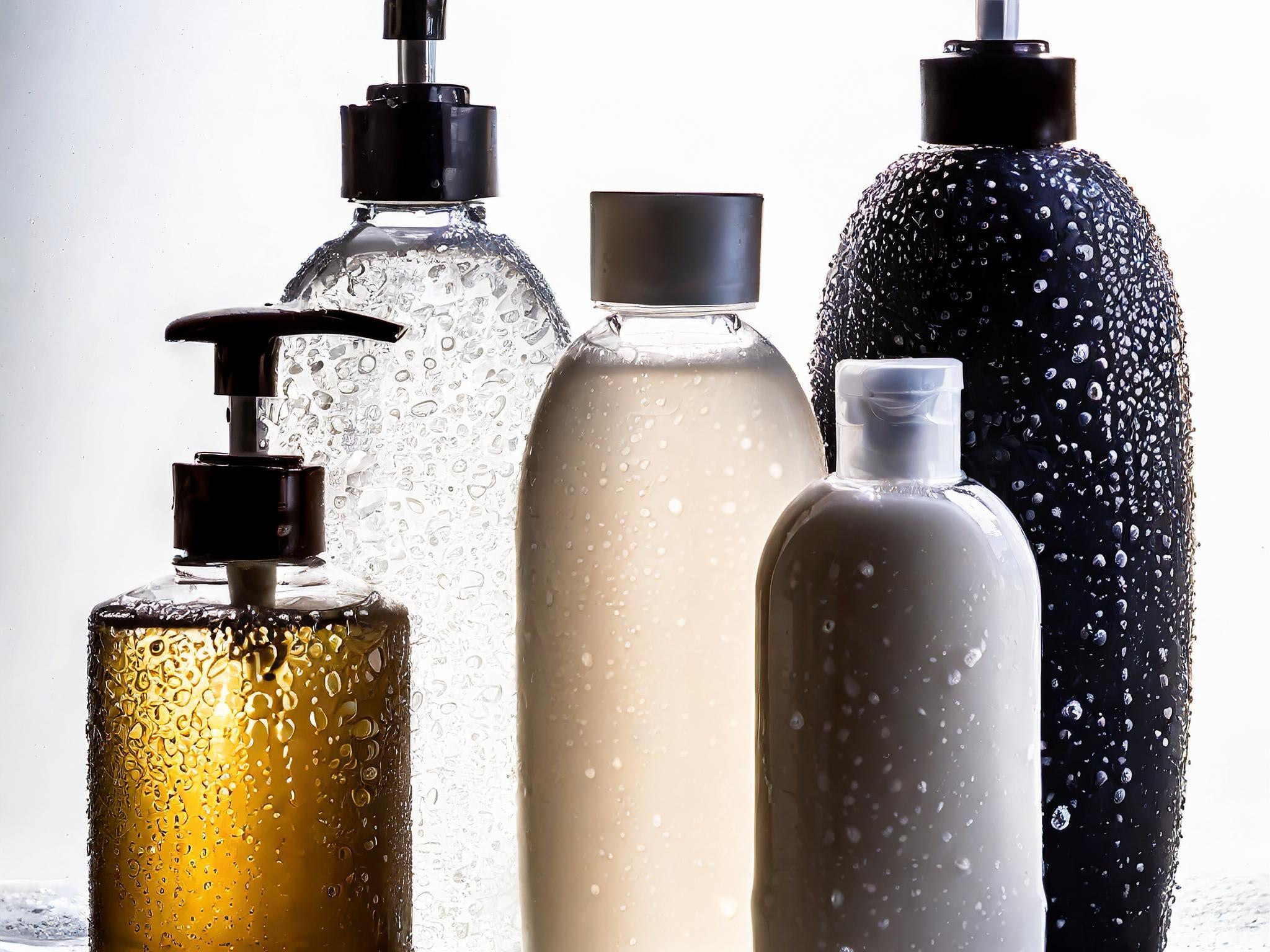 different sized cosmetic bottles on grey background