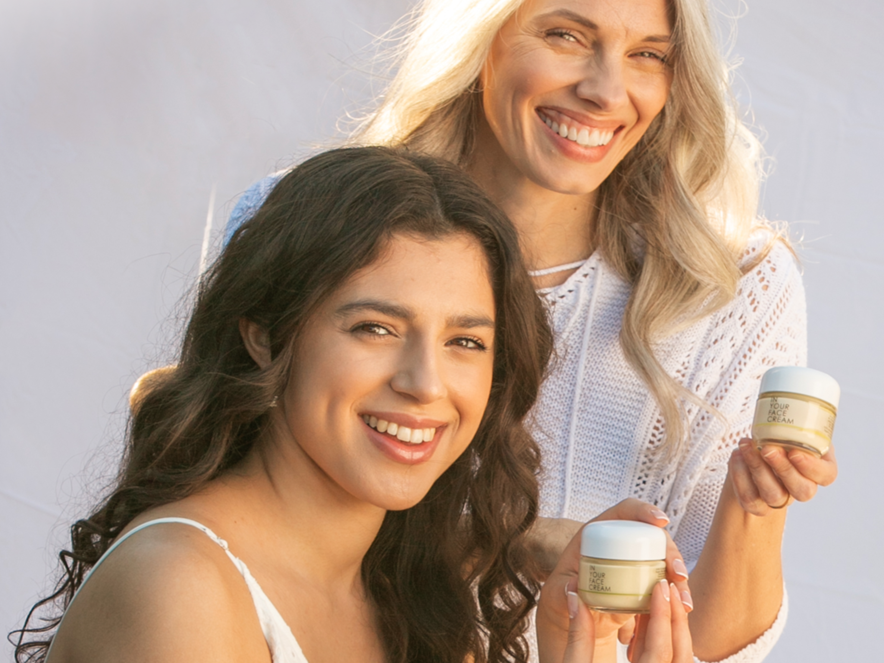 mature woman and young woman holding CREAMs