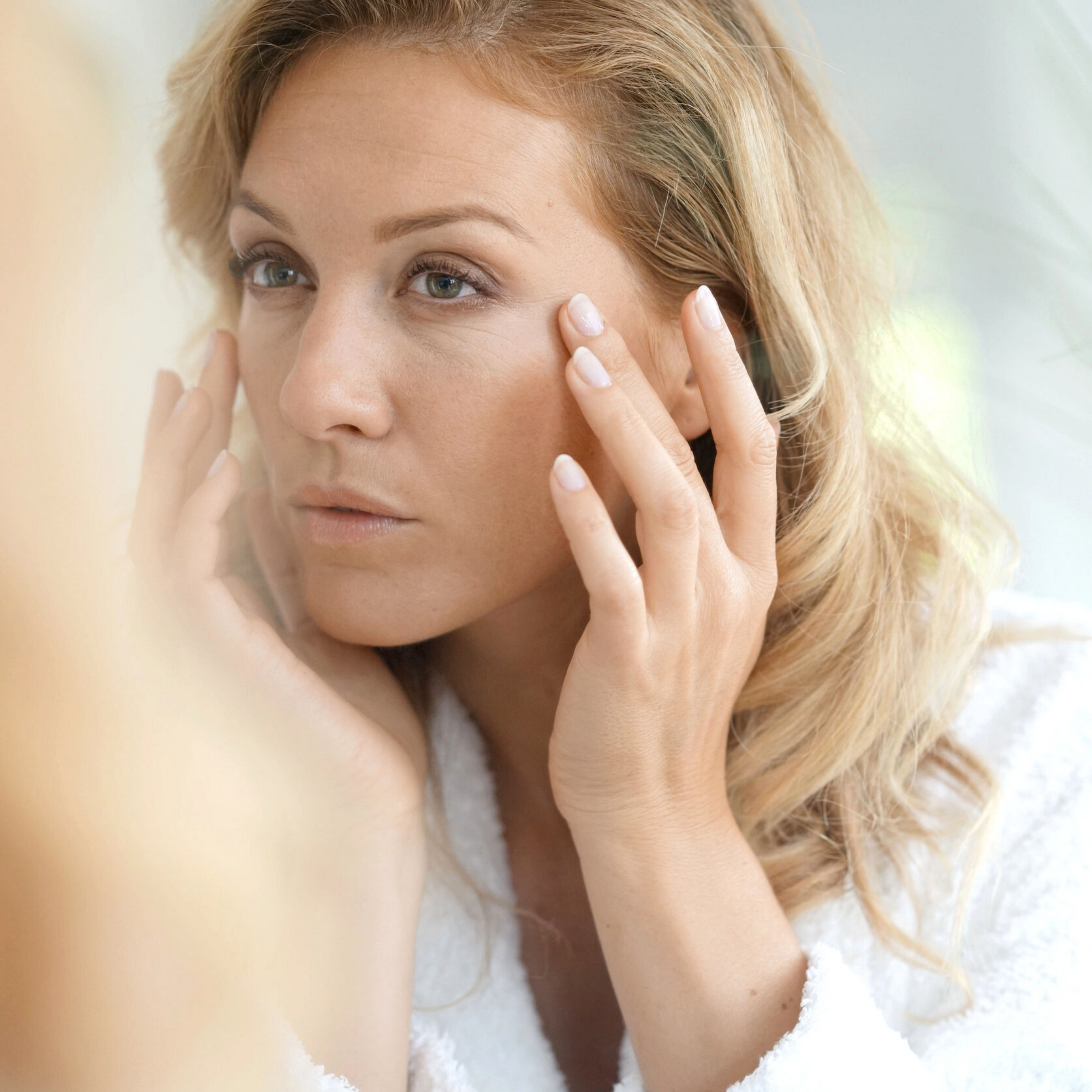 a woman looking in a mirror