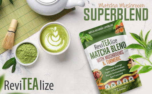 A flat-lay product shot of ReviTEA lize Matcha Mushroom Superblend matcha powder pouch, styled with a cup of matcha latte, matcha powder, a bamboo whisk, and green tea leaves on a white marble surface.